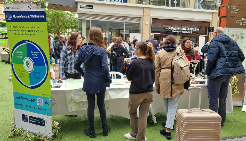 Image of several visitors at the Flourishing and Wellbeing stand during the BRC's Open Day 2024